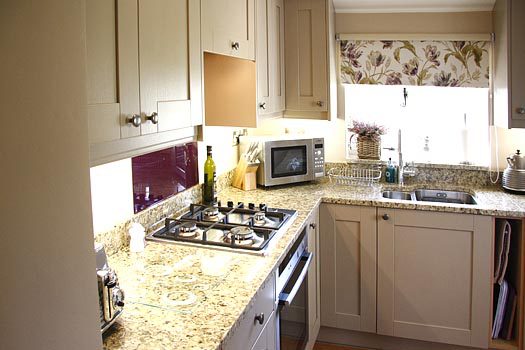 Alternative view of the country kitchen at The Cottage with granite worktops and gas hob