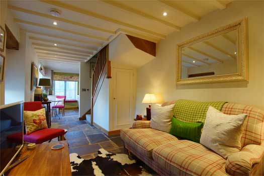 Sitting room at The Dairy with wood-burning stove and comfortable seating