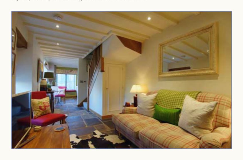 Additional view of the sitting room at The Dairy with checked sofa and country textiles